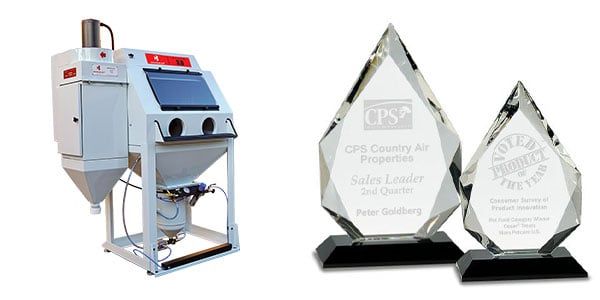 Crystal Blast sand carving machine with two sand etched crystal awards to the right.